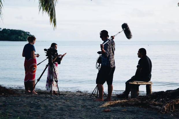 Student film crew on beach