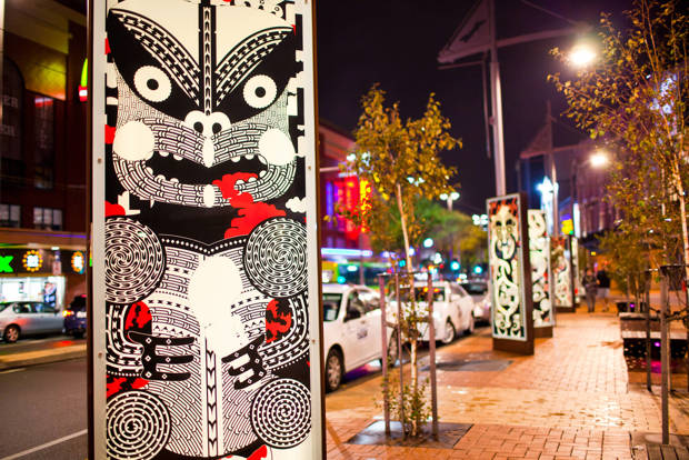 Modern black, white and red Māori face design on lightboxes in Courtenay Place, Wellington