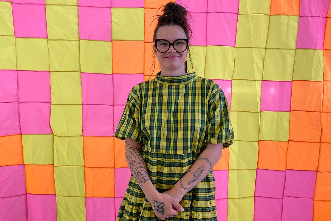 Turumeke Harrington with her work [Longer than I can remember], previously shown at Toi Pōneke.